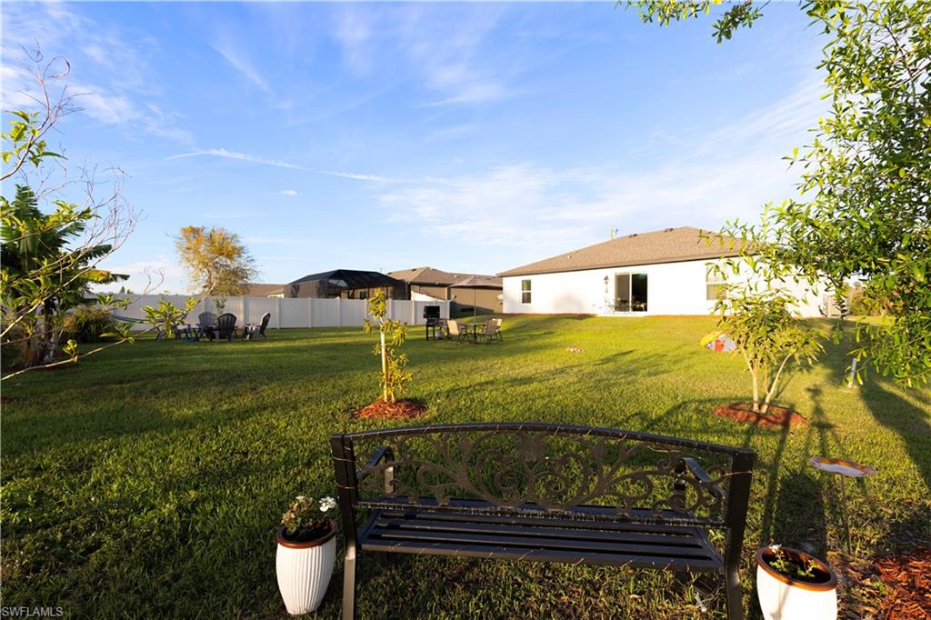 Expansive green lawn with a privacy fence