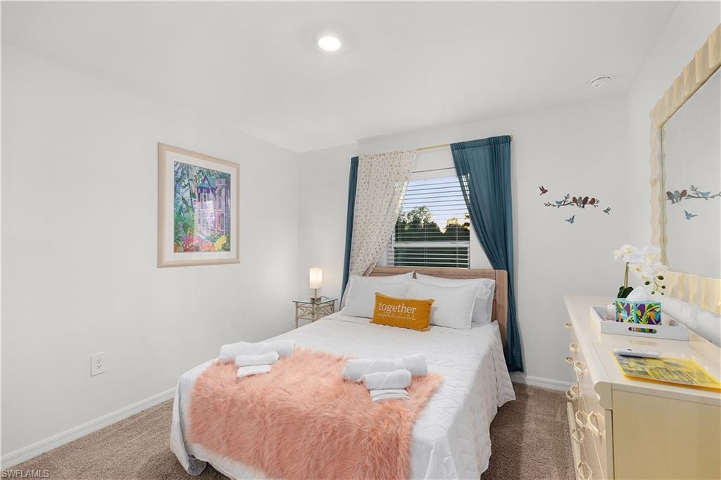 White walls with a single window featuring blinds and blue drapes