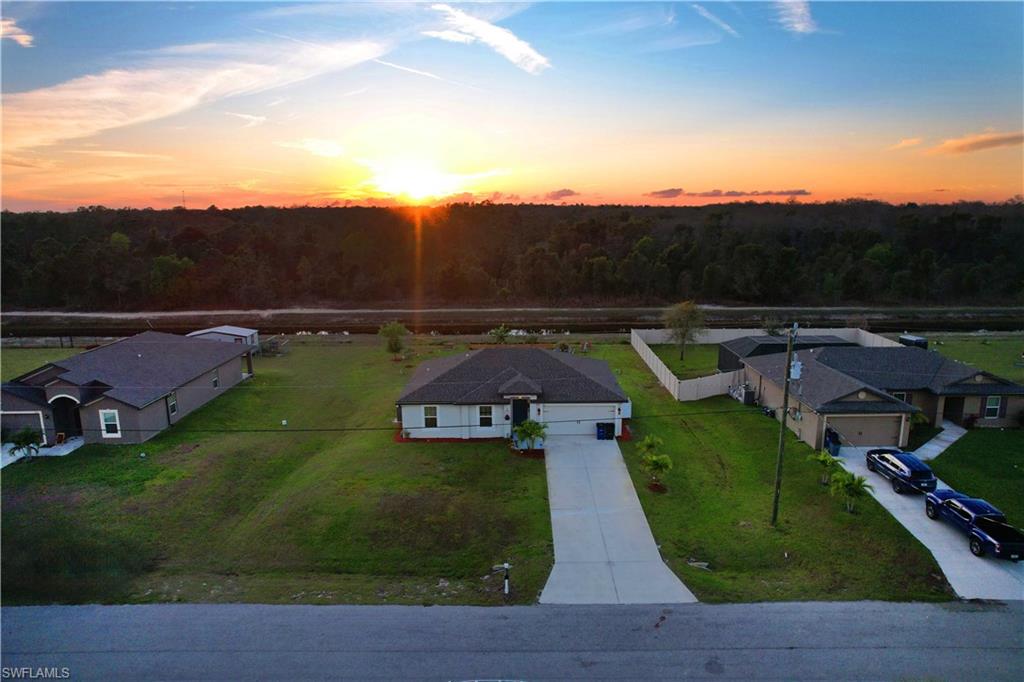 Single-story residence with an attached two-car garage, concrete driveway, and a fenced backyard