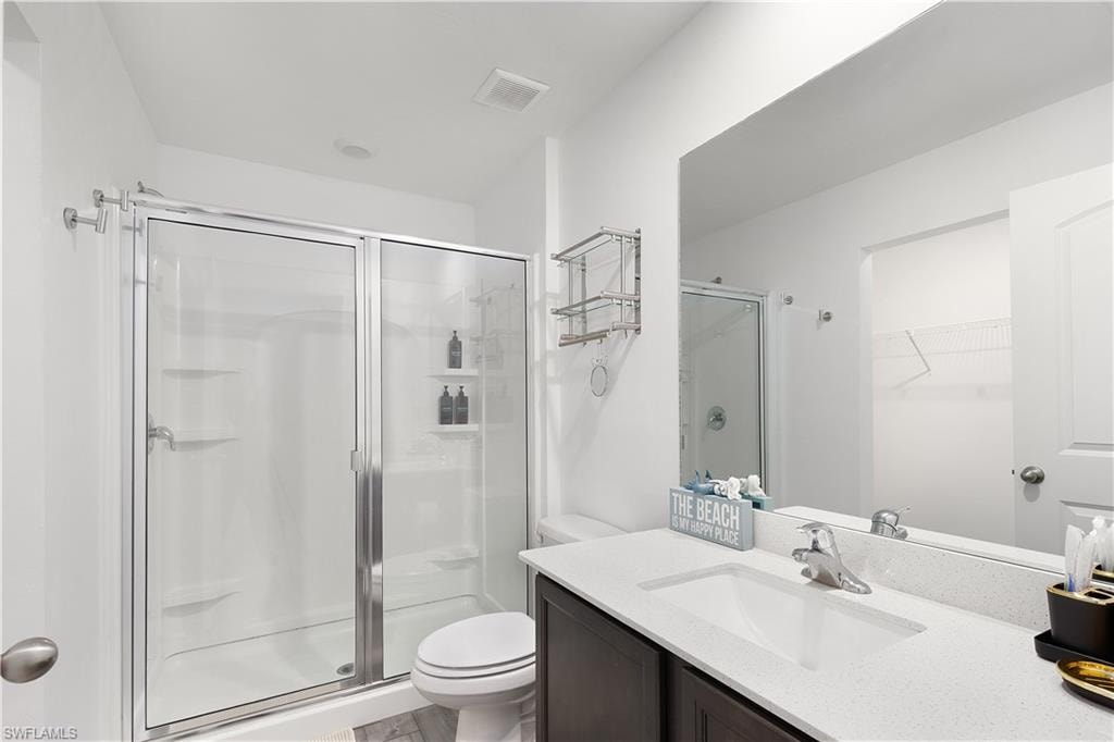 White vanity with an integrated sink, polished chrome faucet, and quartz countertop
