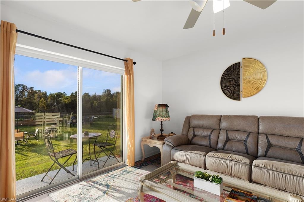 Sliding glass doors opening to an outdoor patio with a grassy area