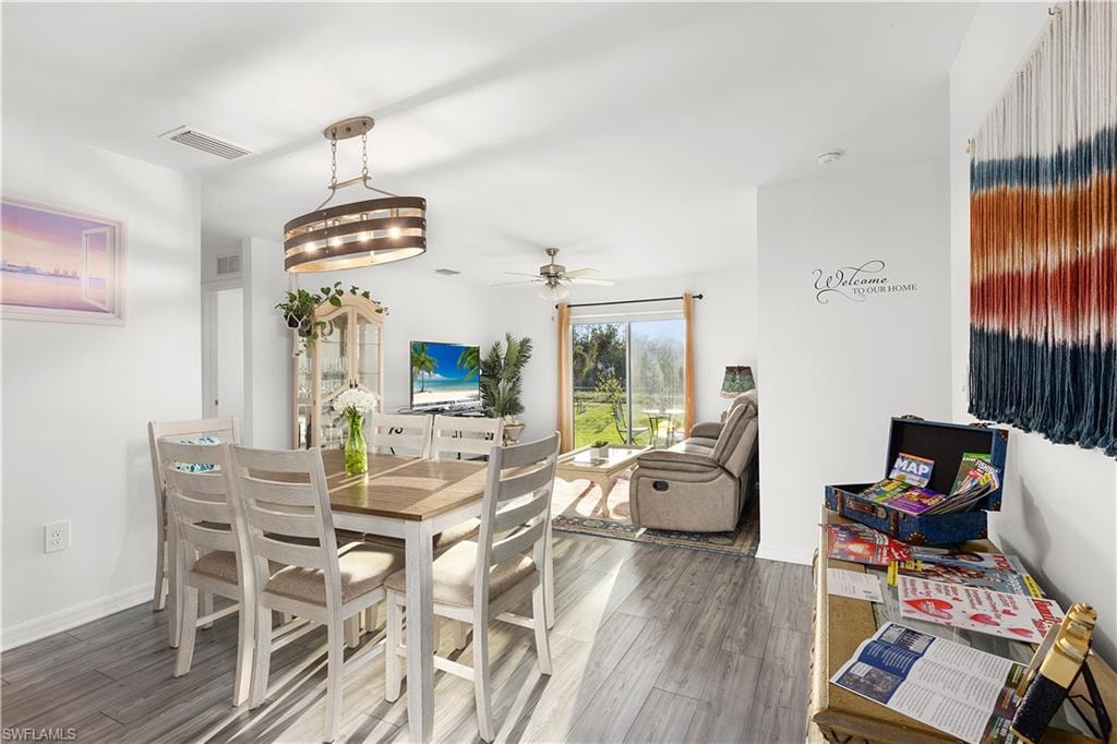 Wood-finish flooring throughout, with a decorative ceiling light fixture