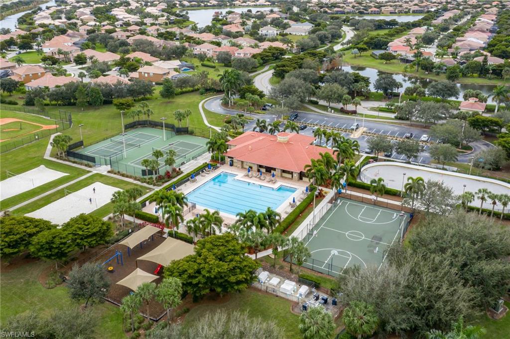 Community amenities featuring an outdoor swimming pool, multiple tennis courts, a basketball court, and a shaded playground area