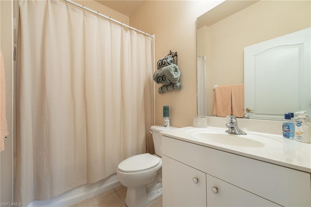 Spa-inspired bathroom featuring a vanity with dual sinks, abundant counter space, and brushed nickel fixtures