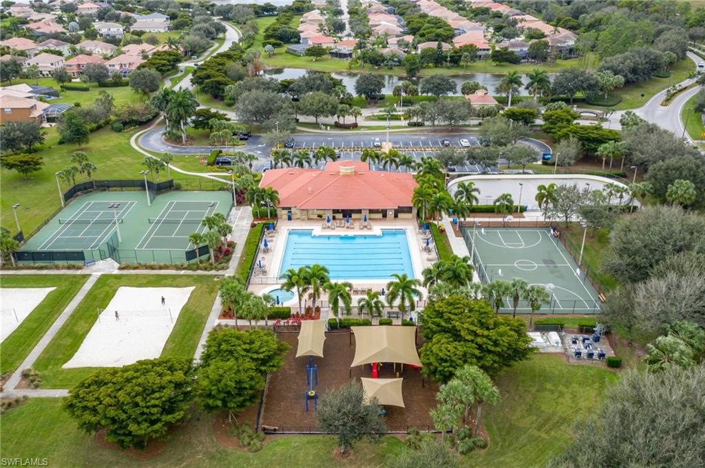 Community amenities featuring a large outdoor swimming pool, two tennis courts, a basketball court, a sand volleyball court, and a covered playground area