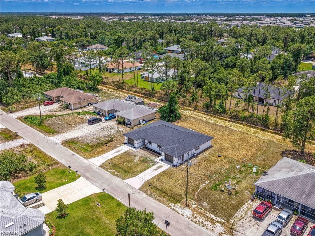 Newly constructed residence situated on an expansive lot surrounded by mature pine trees