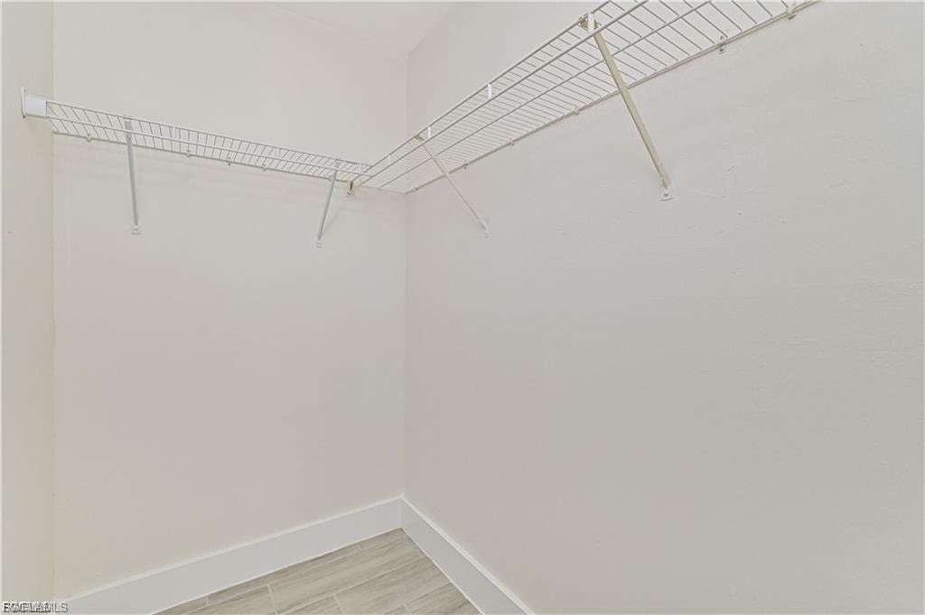 Corner storage shelving with white wire racks and support brackets