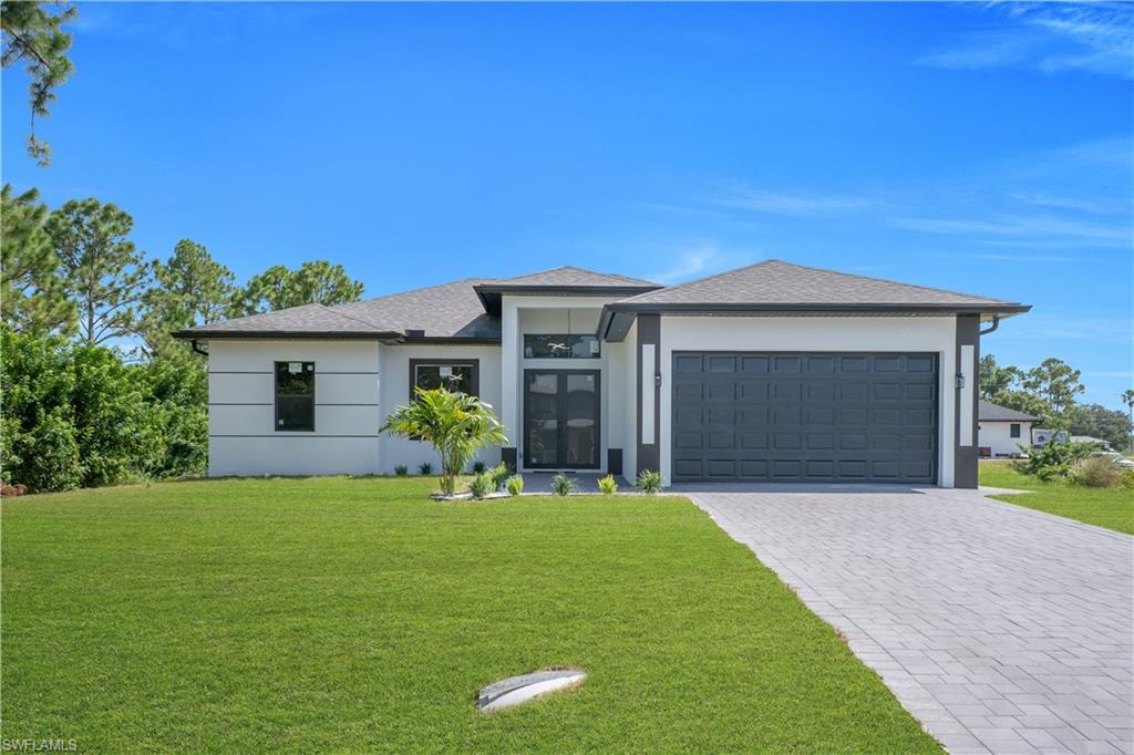 Contemporary exterior with a dark grey roof, light-colored stucco, and dark trim accents