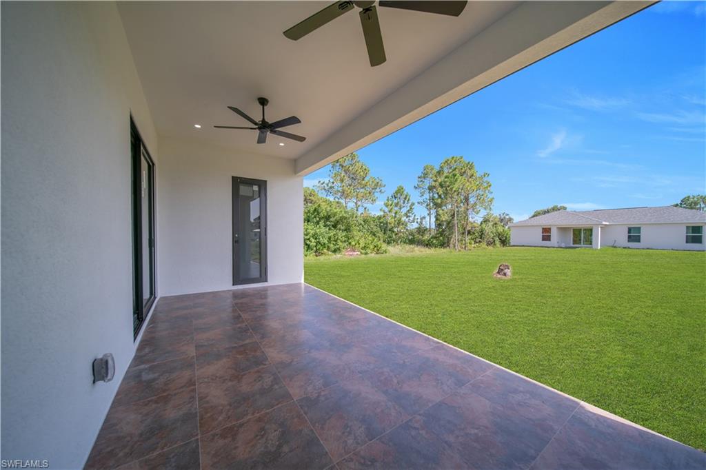 Covered patio with tile flooring, recessed lighting, and dual ceiling fans