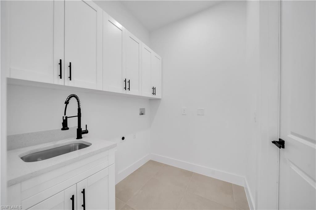 White cabinetry with black hardware, integrated sink, and gooseneck faucet