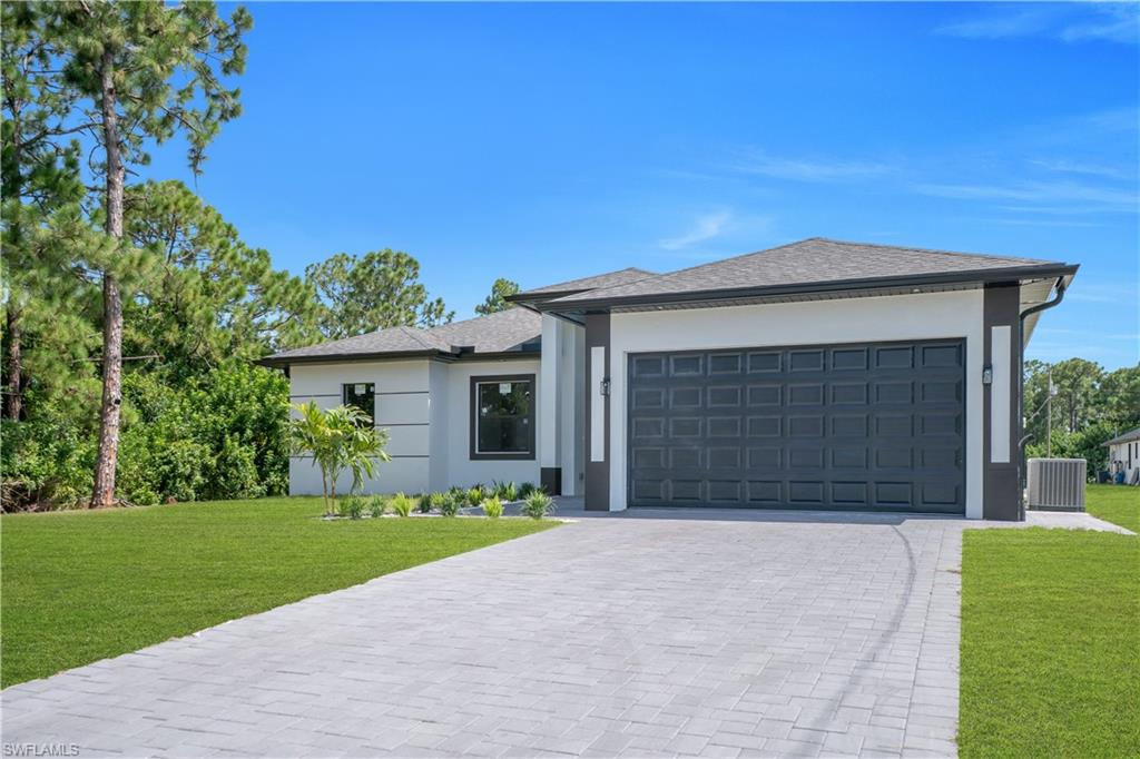 Stucco exterior with a dark-paneled garage door