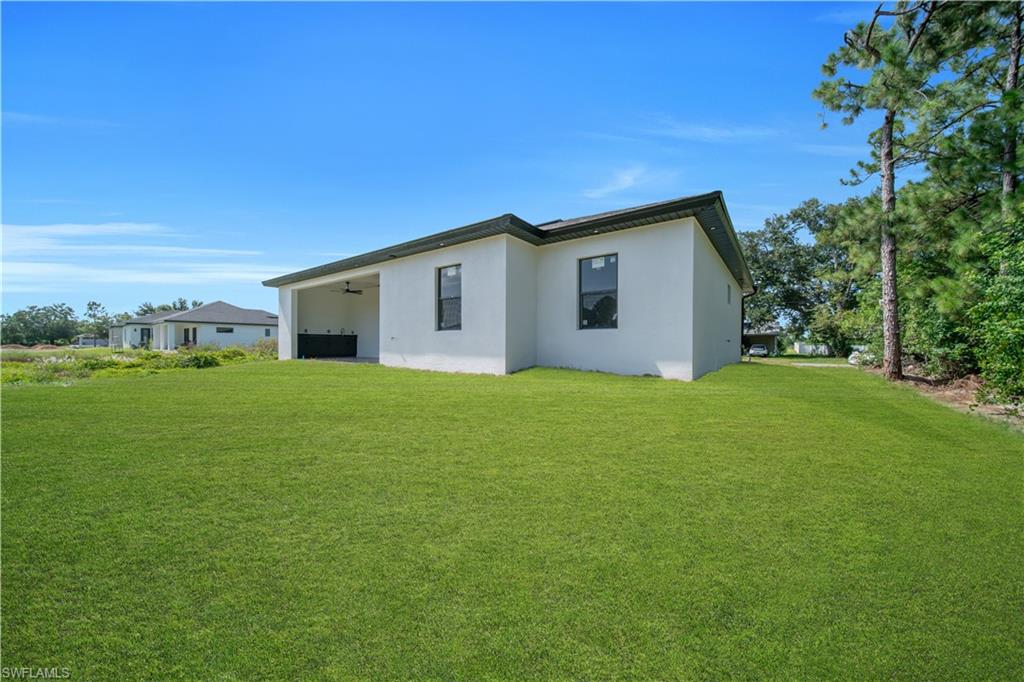 Expansive green lawn surrounds the property