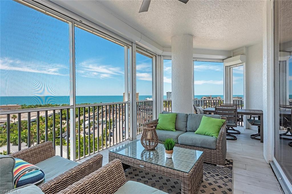 Sunroom / solarium with a water view, wood finished floors, and a textured ceiling
