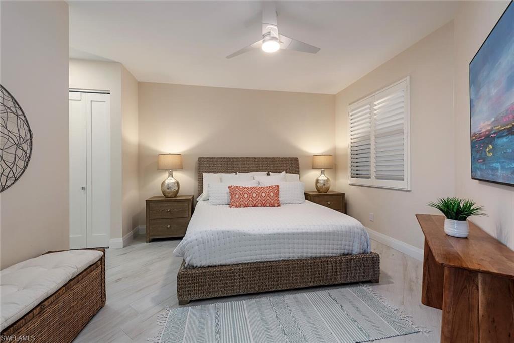 Bedroom featuring baseboards, light wood-style flooring, a ceiling fan, and a closet