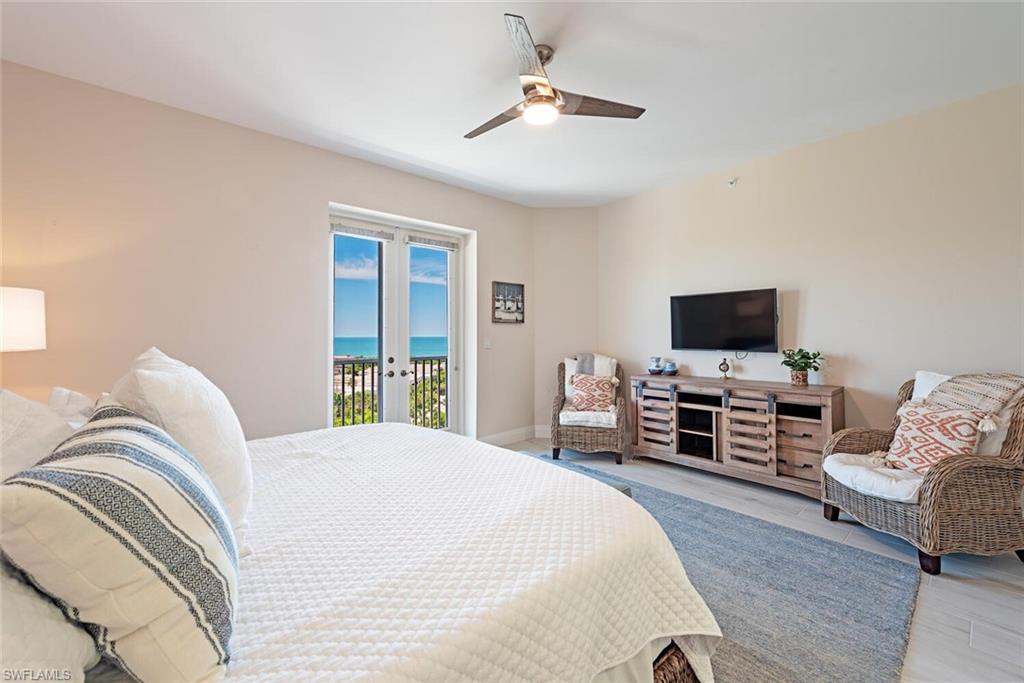 Bedroom featuring access to exterior, french doors, a ceiling fan, and baseboards