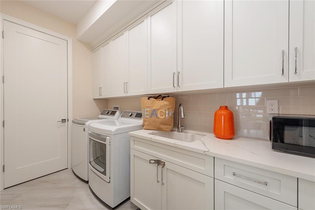 Laundry area with cabinet space and washer and dryer