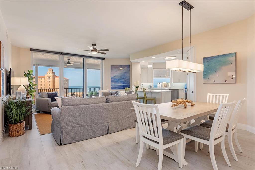 Dining area with a ceiling fan and expansive windows