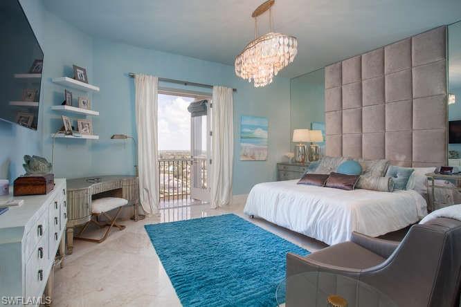 Bedroom with access to outside, a chandelier, and light colored carpet