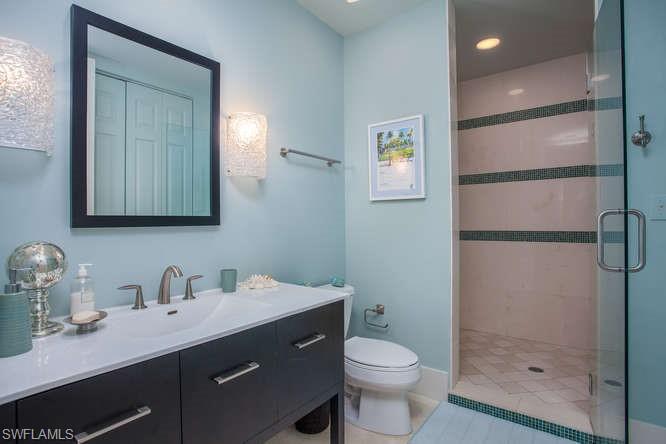 Full bathroom featuring a shower stall, vanity, toilet, and recessed lighting
