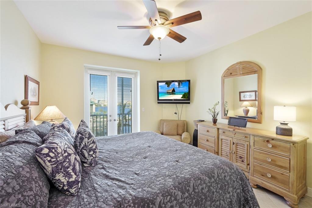 Bedroom with light tile patterned floors, french doors, a ceiling fan, and access to outside
