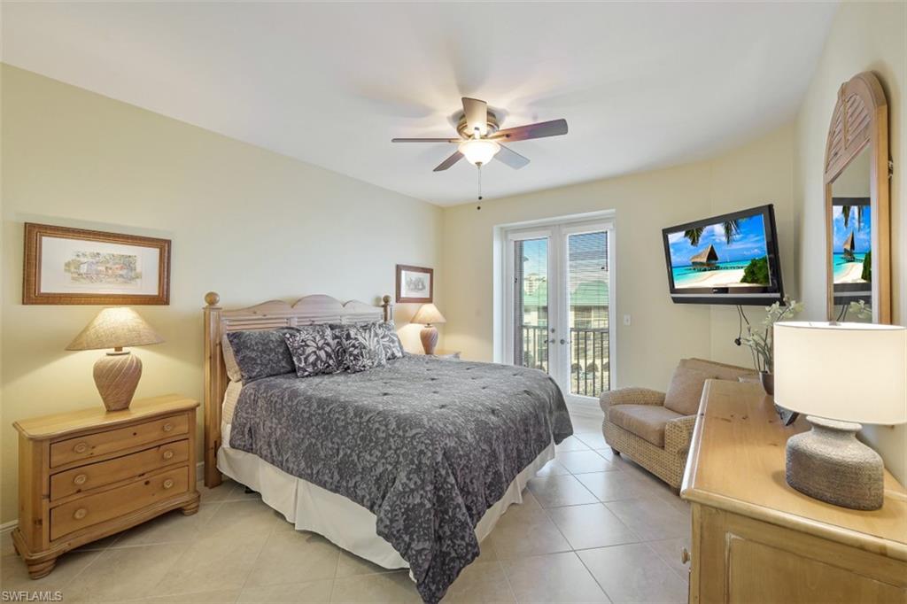 Bedroom featuring light tile patterned floors, french doors, a ceiling fan, and access to outside