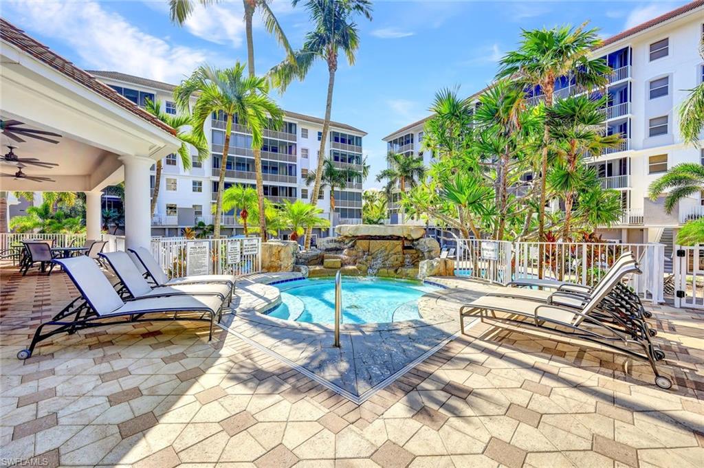 Community pool featuring fence, a patio, and ceiling fan