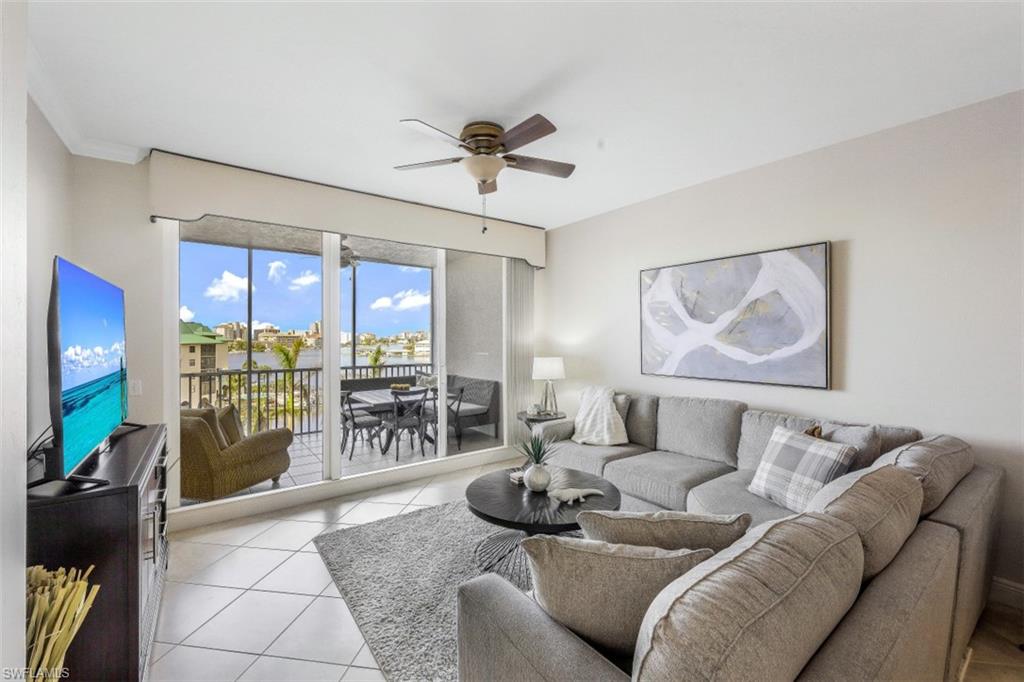 Living room featuring light tile patterned flooring and a ceiling fan