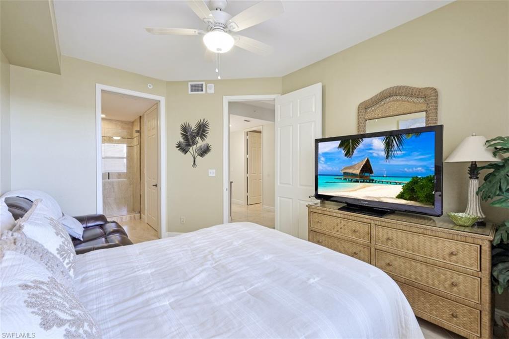 Bedroom with visible vents, ensuite bathroom, and ceiling fan