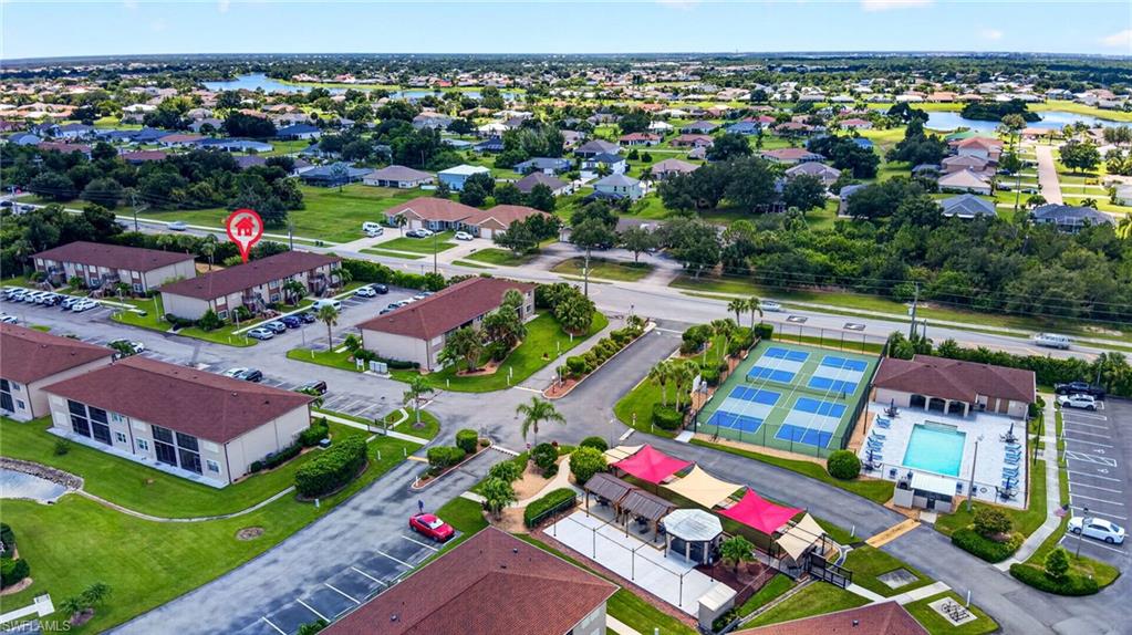 Expansive property featuring multiple residential structures, an outdoor pool, and tennis courts