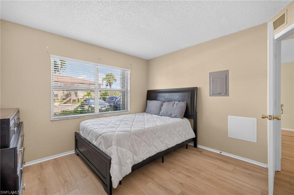 Light wood-finish flooring with white trim
