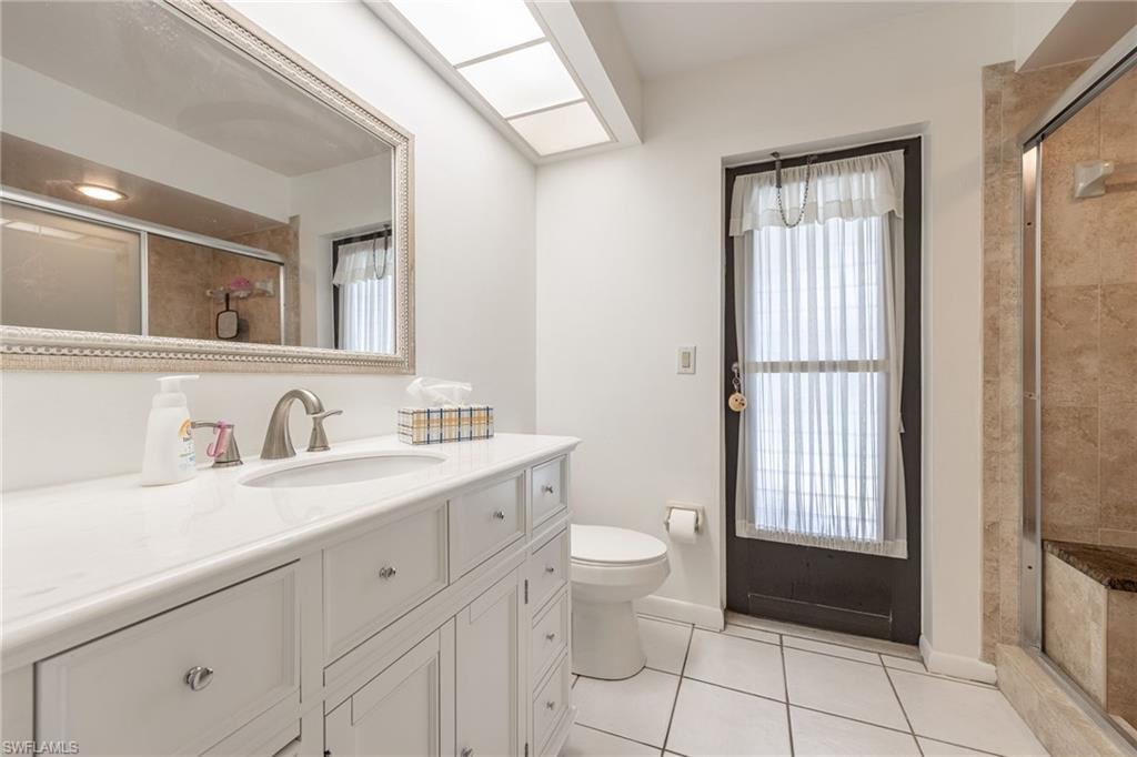 Pool bath-White vanity with an integrated sink and brushed nickel faucet