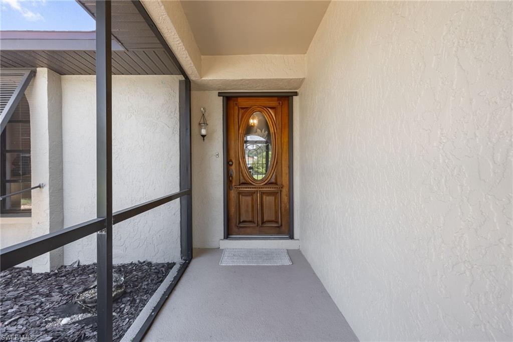 Screened entry porch with textured exterior walls