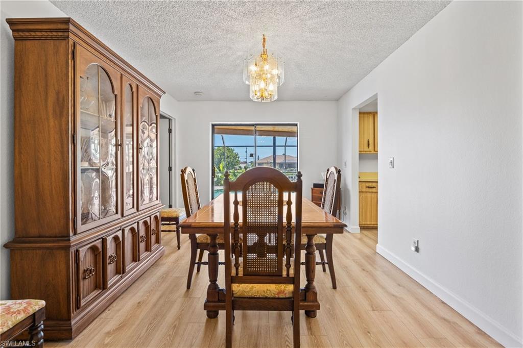 Wood-finish flooring throughout, bright white walls, and a recessed window with a dark frame
