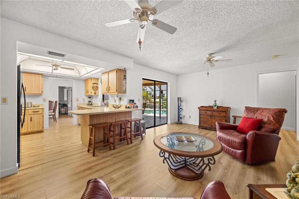 Open concept living area with wood-finish flooring