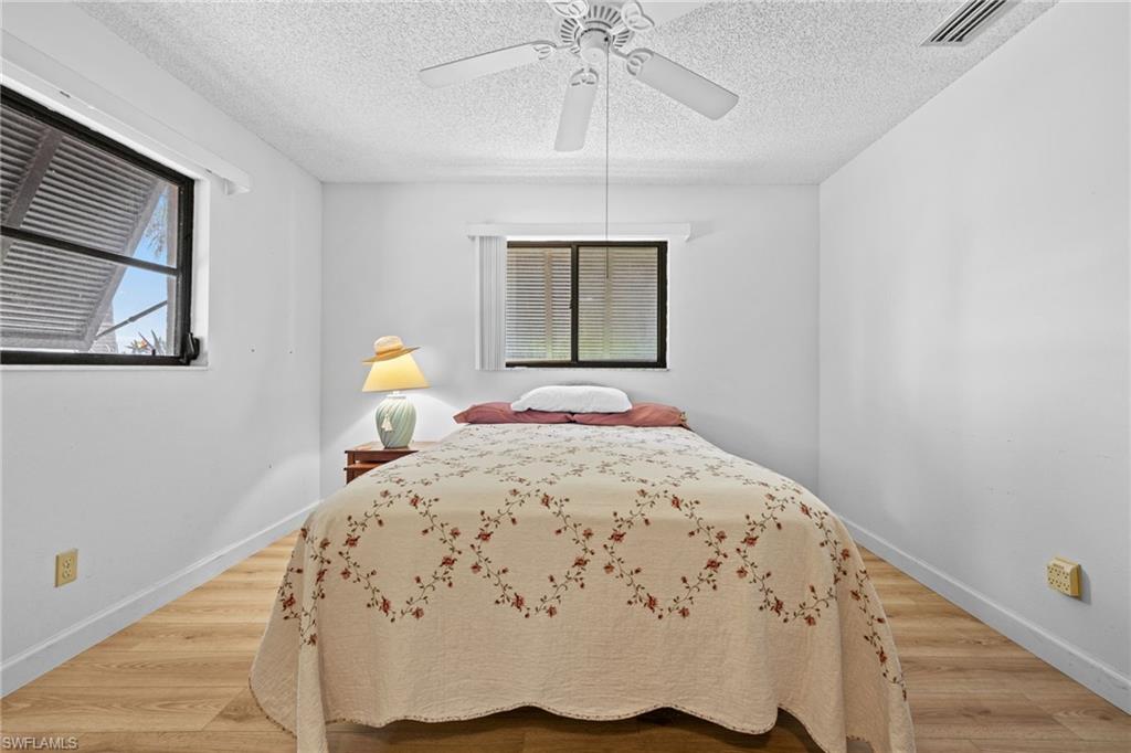 Wood-finish flooring, white walls, and a walk in closet!