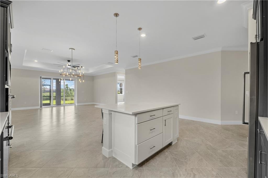 Central kitchen island with white cabinetry and a light-toned countertop
