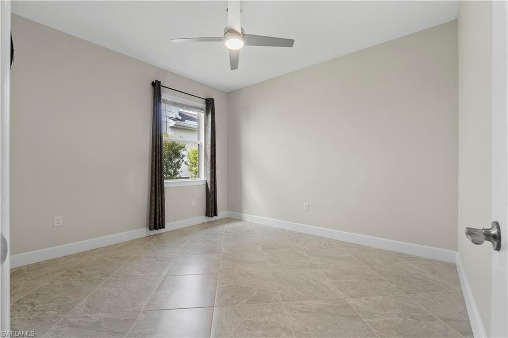 Recessed window with dark curtains, ceiling fan with integrated lighting, and tile flooring