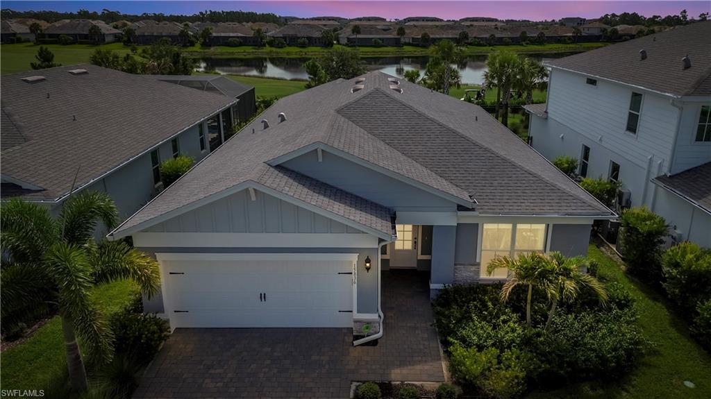 Single-story residence featuring a gray shingle roof, light blue siding, and white trim accents
