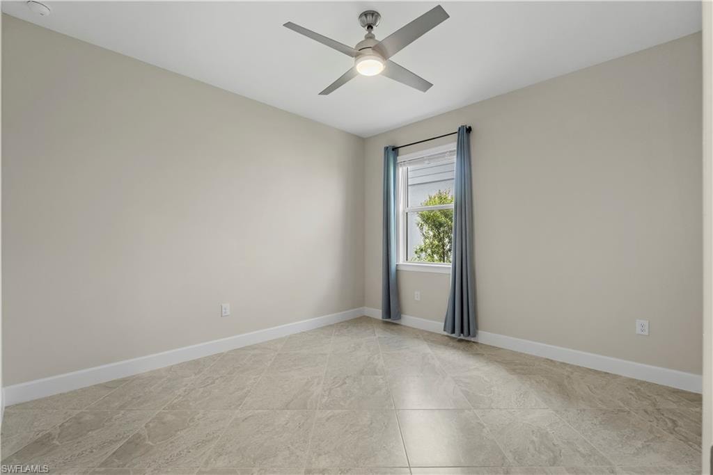 Recessed lighting, ceiling fan with integrated light, window with natural light, tile flooring, and neutral wall tones