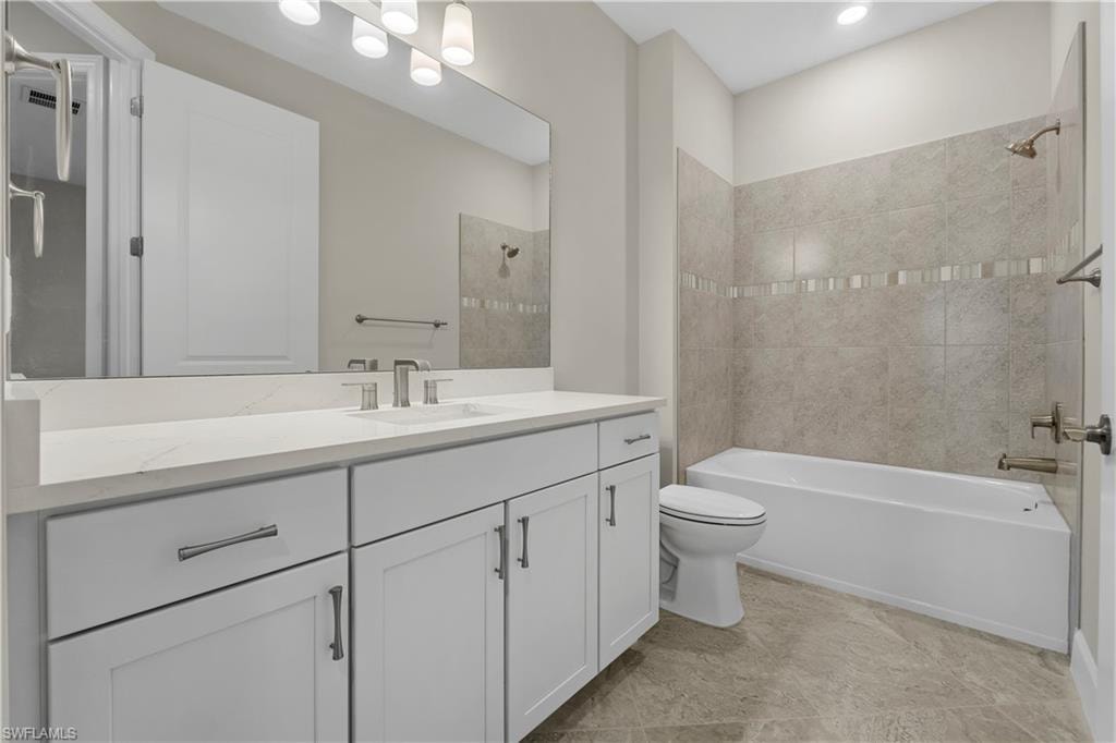 White vanity with brushed nickel hardware, light-toned countertop, rectangular undermount sink, and full-width mirror