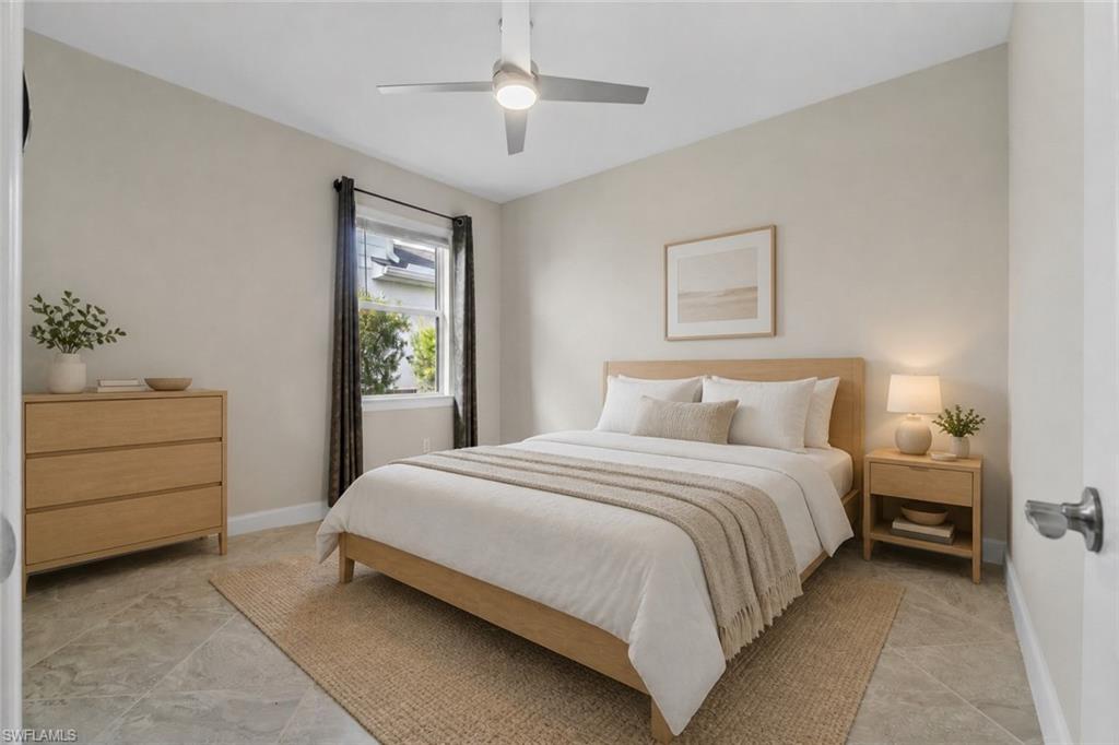 Recessed lighting and a ceiling fan fixture complement the light-toned walls