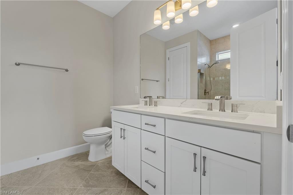 Dual-sink vanity with white cabinetry, light-toned countertop, and brushed nickel fixtures