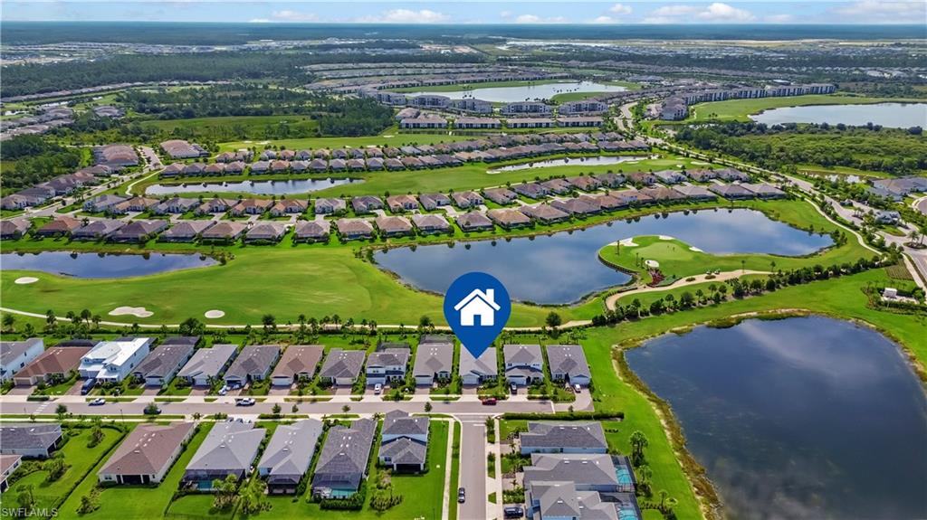 Aerial perspective showcasing a residential community with water features, expansive green spaces, and a golf course