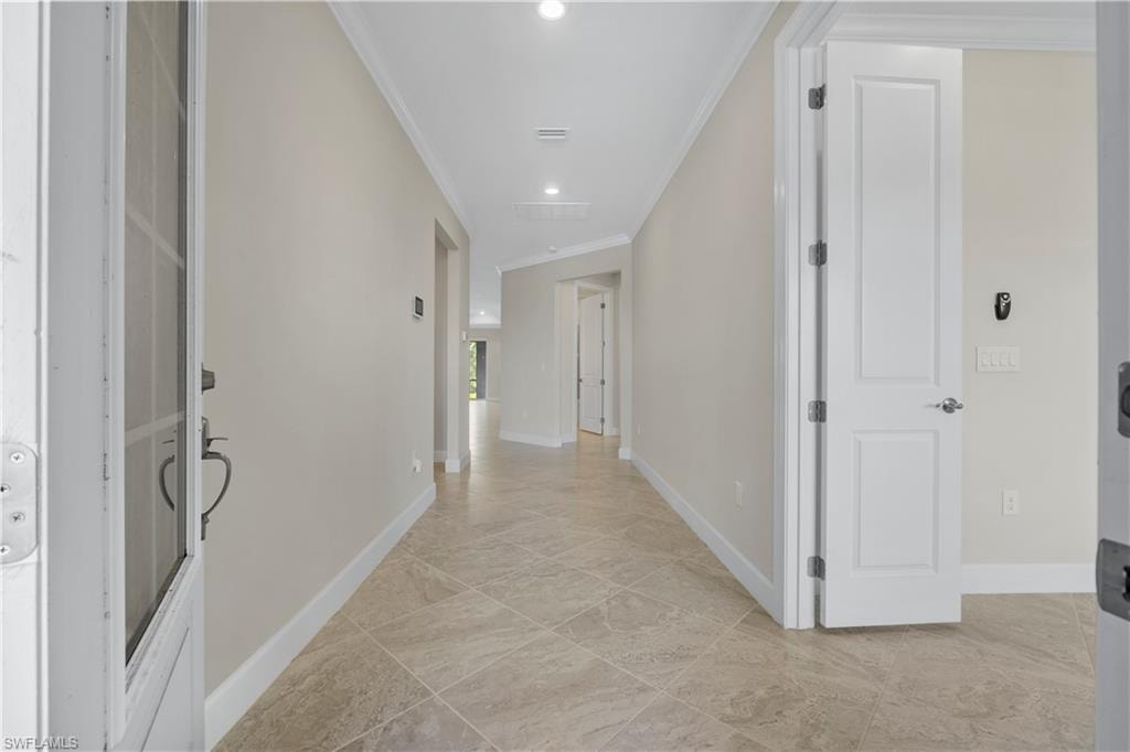 Tile flooring throughout, recessed lighting, and crown molding