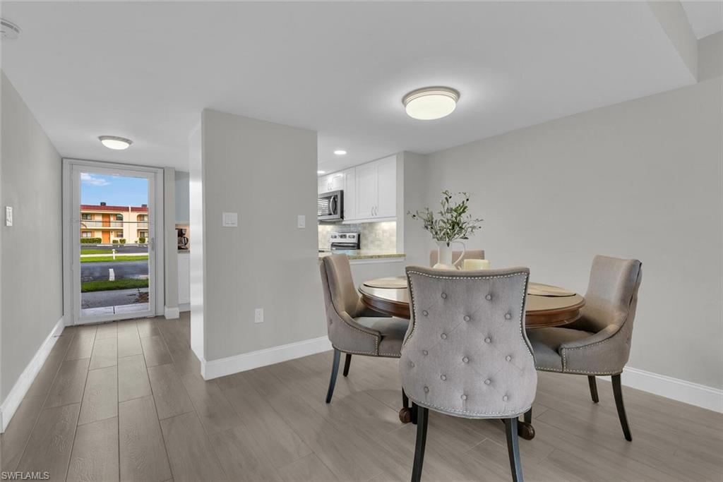 Open-concept living space with wood-finish flooring and recessed ceiling lights