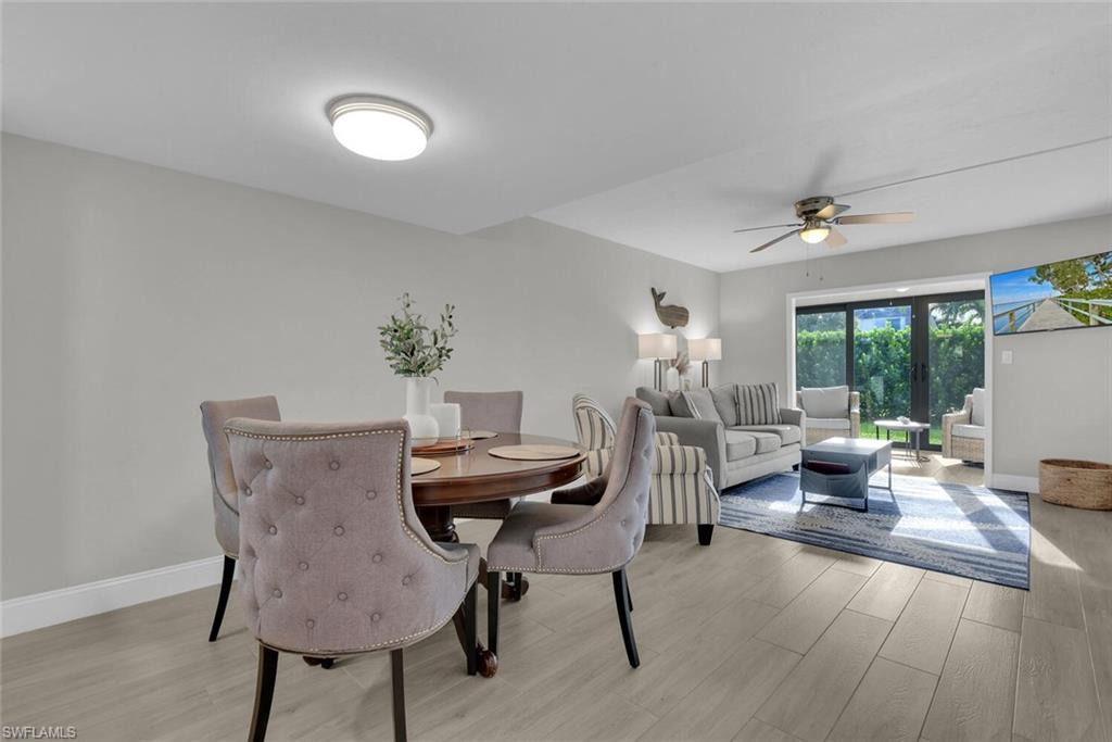 Wood-finish flooring, recessed lighting, ceiling fan, and sliding glass doors