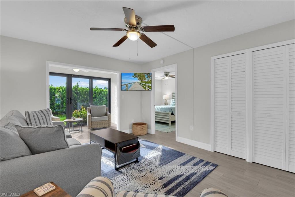 Recessed lighting, wood-finish flooring, ceiling fan, and white louvered closet doors