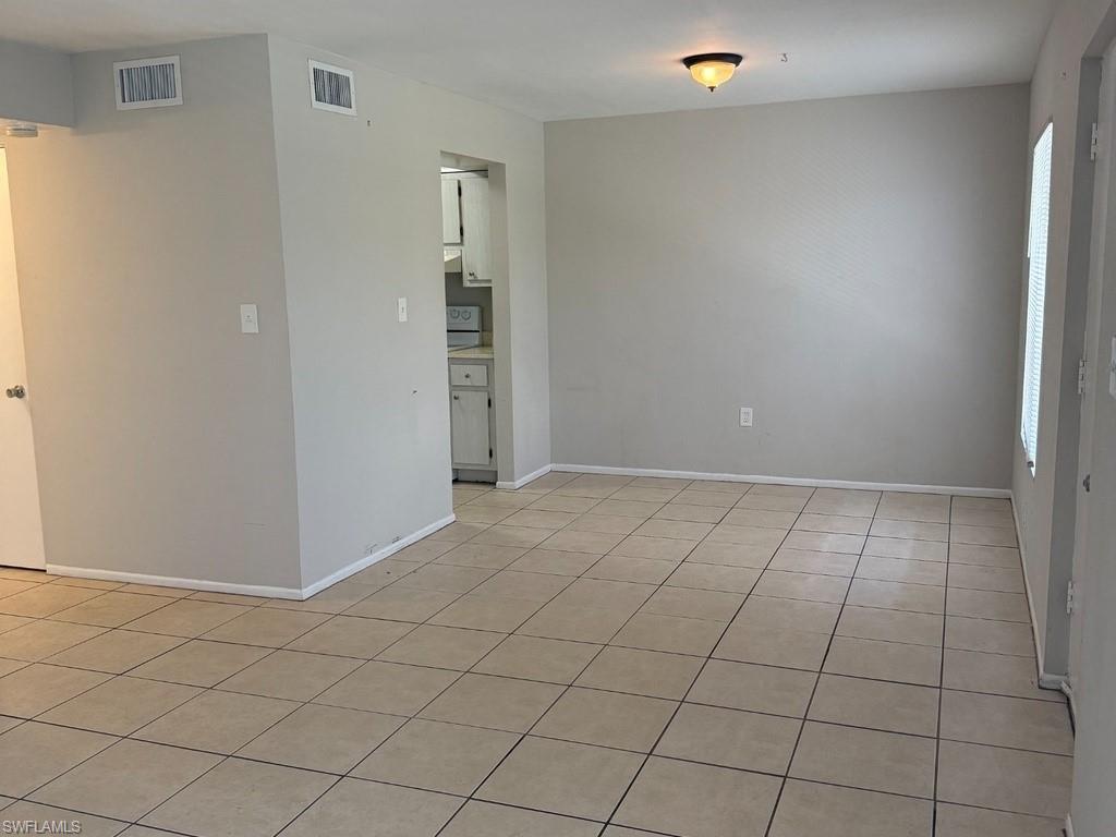 Neutral wall finishes, recessed ceiling light fixture, durable tile flooring, and integrated window blinds