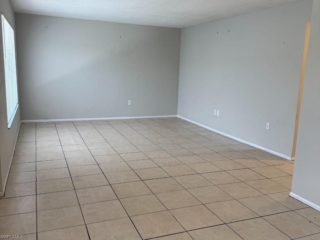 Neutral wall colors, tile flooring, window with blinds
