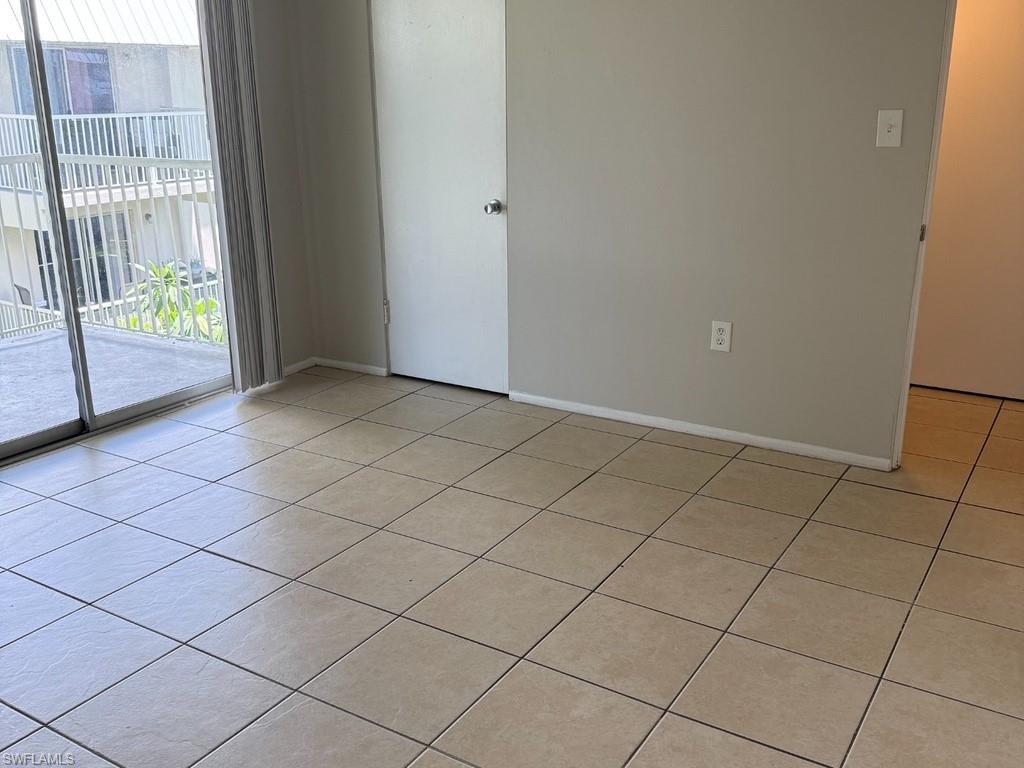 Tile flooring, light gray wall paint, sliding glass door, white trim, white interior door